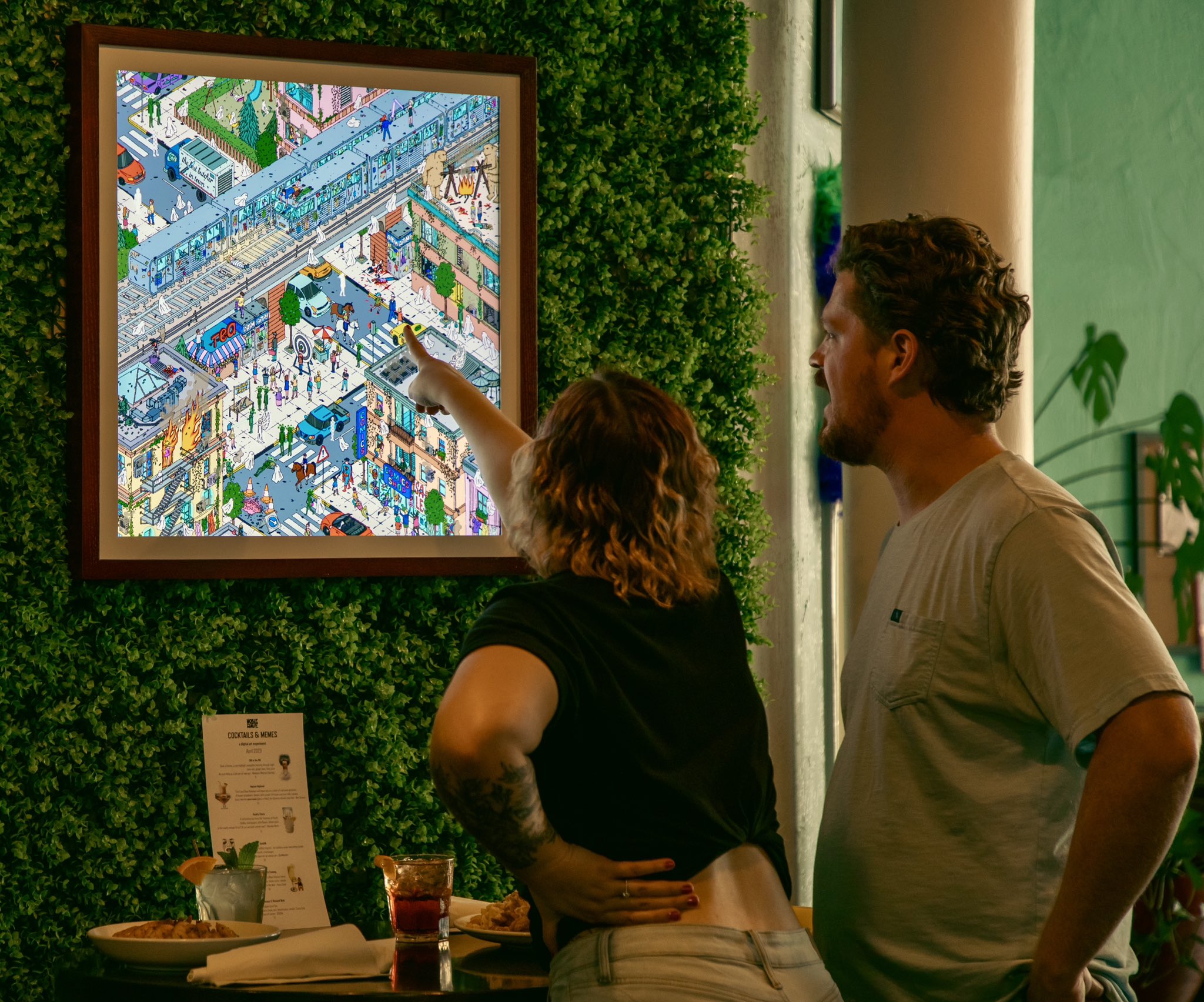 A woman points at a dense, colorful image on a TokenFrame